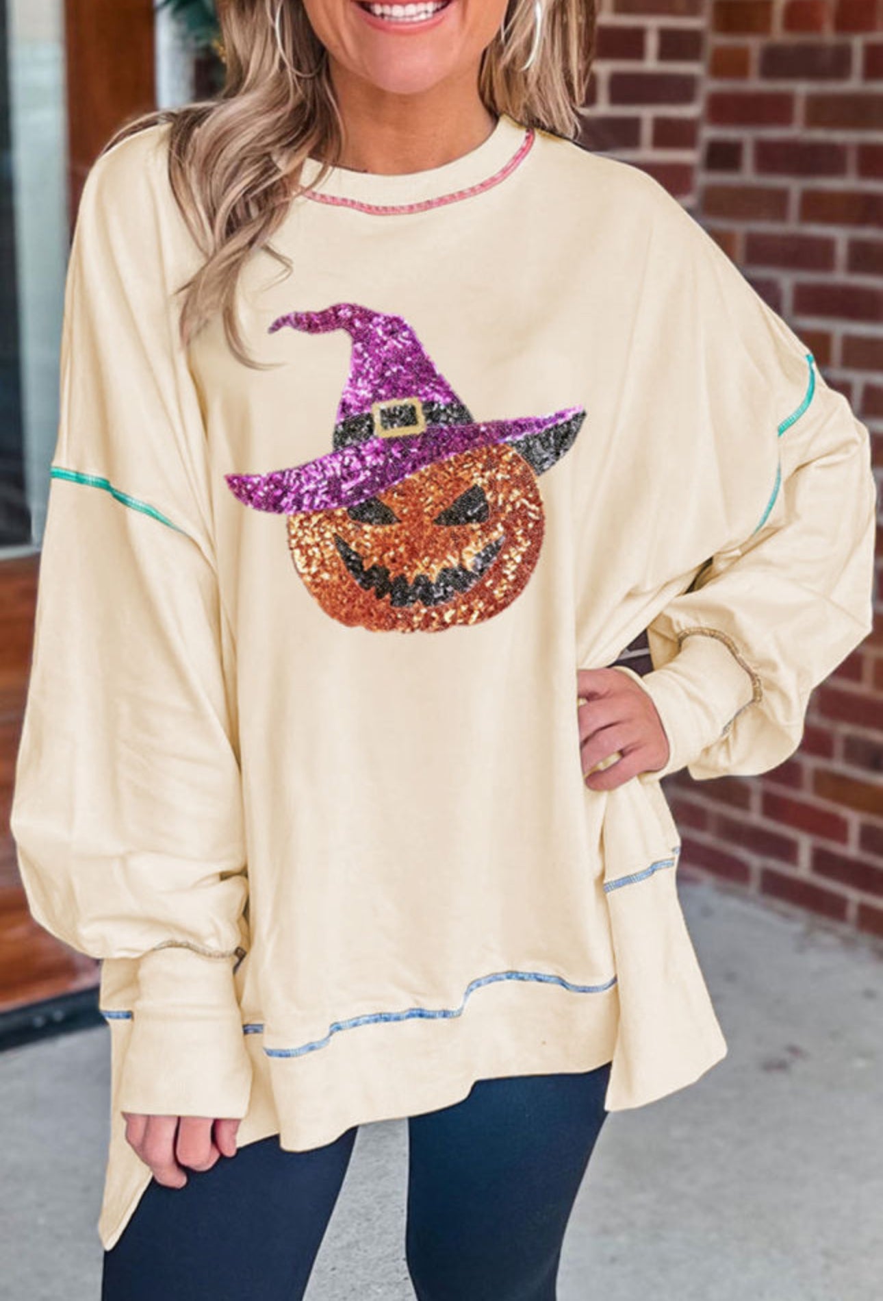 Exposed seam sequin pumpkin pull over